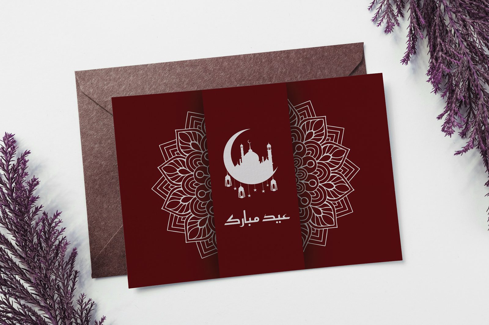 Deep red Eid greeting card with gold mandala ornament, shown with a second card behind it