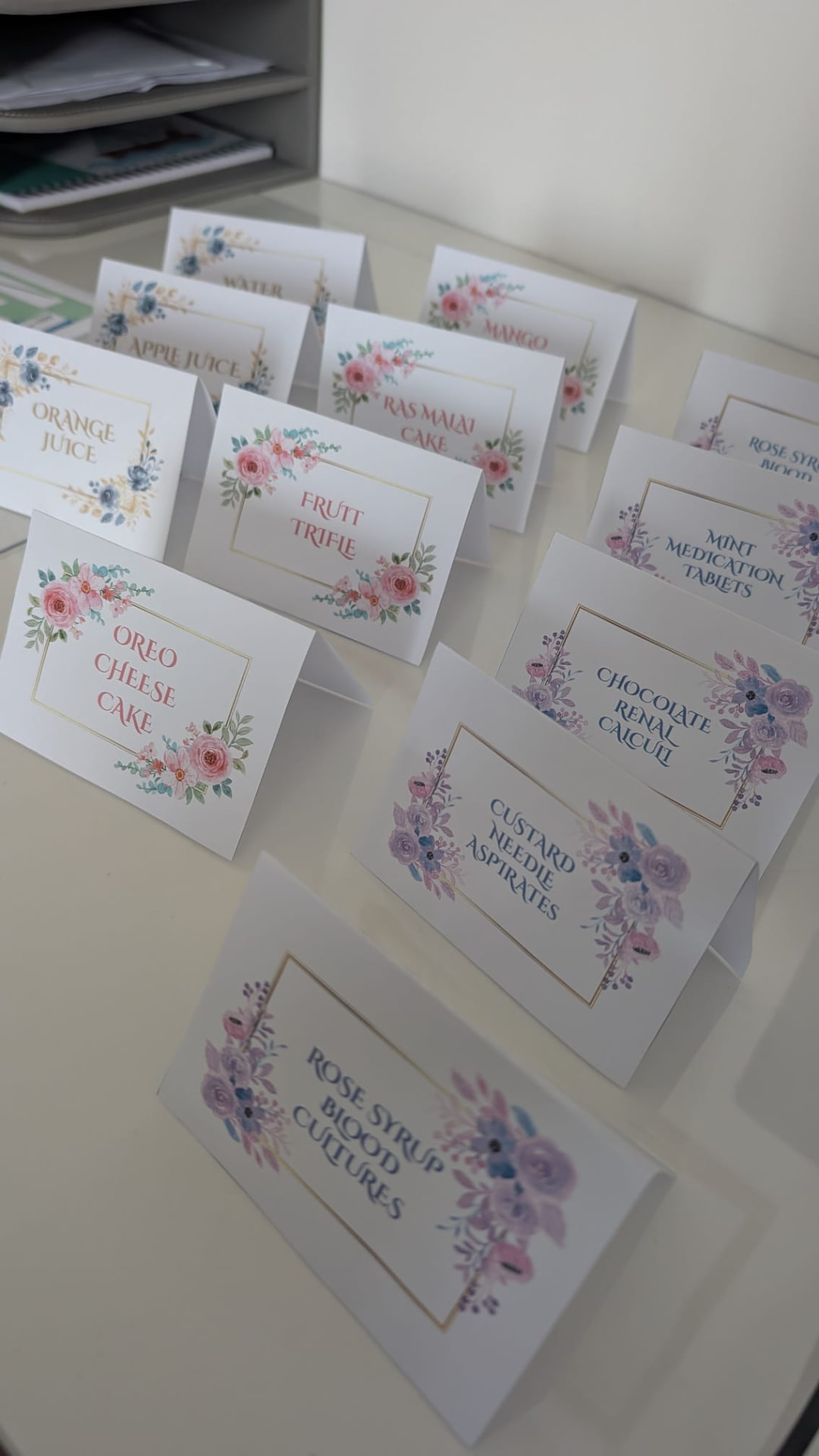 Folded floral food labels standing on a table